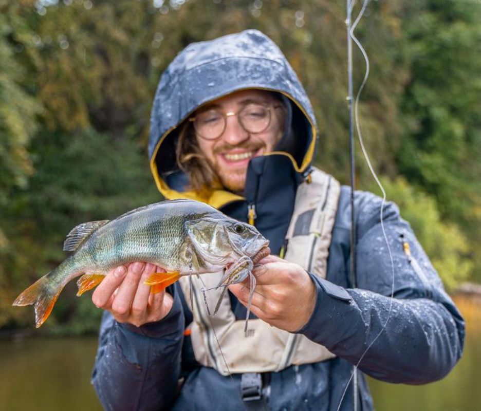 Hausboot-Angler mit Barsch