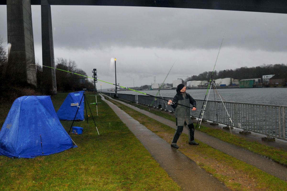 Angler wirft aus beim Plattfischangeln im Nord-Ostsee-Kanal